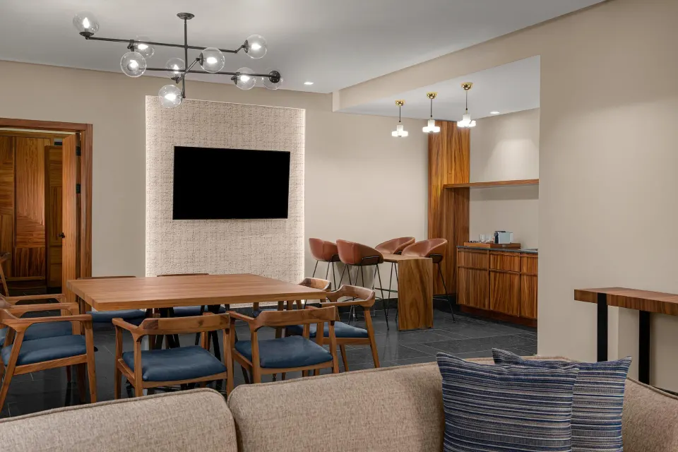 Ceiba Governors Suite dining area with bar seating and TV at Conrad Tulum Riviera Maya.
