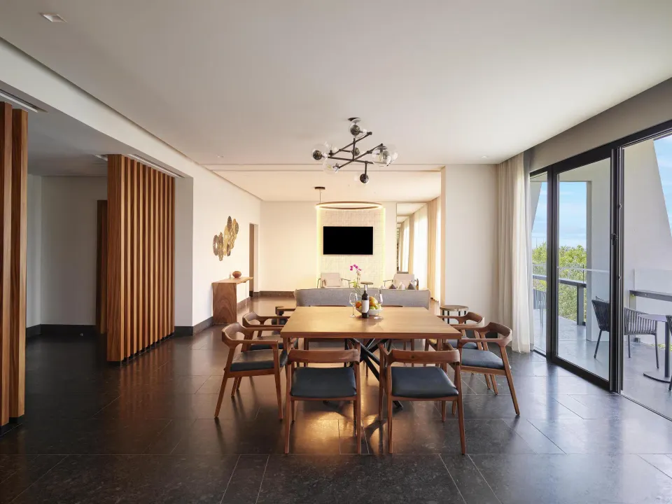 Ceiba Governors Suite dining and living area with balcony at Conrad Tulum Riviera Maya.