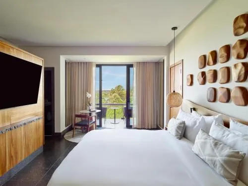 Ceiba Presidential Suite bedroom with king bed and balcony at Conrad Tulum Riviera Maya.
