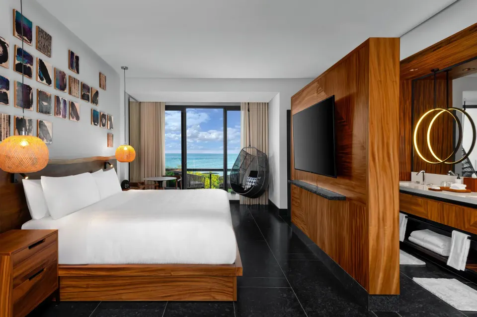 Partial Ocean View Guestroom king bed with balcony ocean view at Conrad Tulum Riviera Maya.