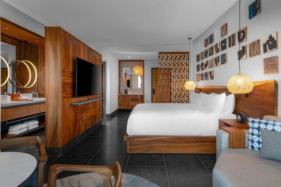 Partial Ocean View Guestroom king bed and vanity at Conrad Tulum Riviera Maya.