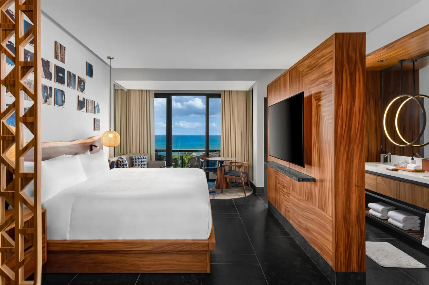 Partial Ocean View Guestroom king bed facing balcony and ocean at Conrad Tulum Riviera Maya.
