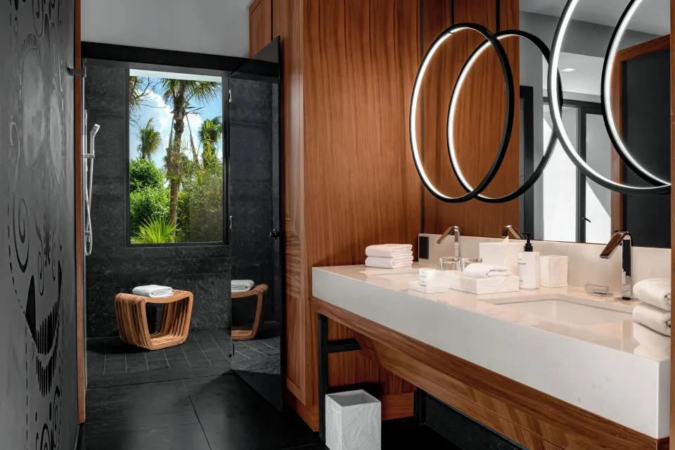 Accessible bathroom with vanity and roll-in shower at Conrad Tulum Riviera Maya.