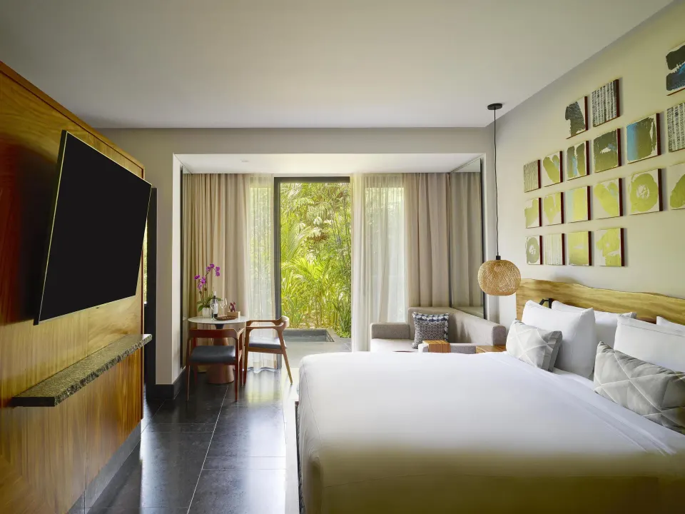Ceiba Tropical View suite king bed with tropical garden window at Conrad Tulum Riviera Maya