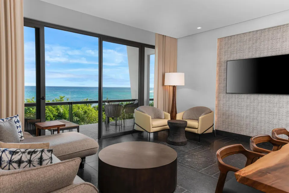 Ocean View Suite living room and balcony at Conrad Tulum Riviera Maya overlooking the sea.
