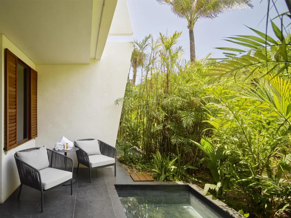 Tropical View Guestroom patio at Conrad Tulum Riviera Maya with plunge pool and seating amid greenery.