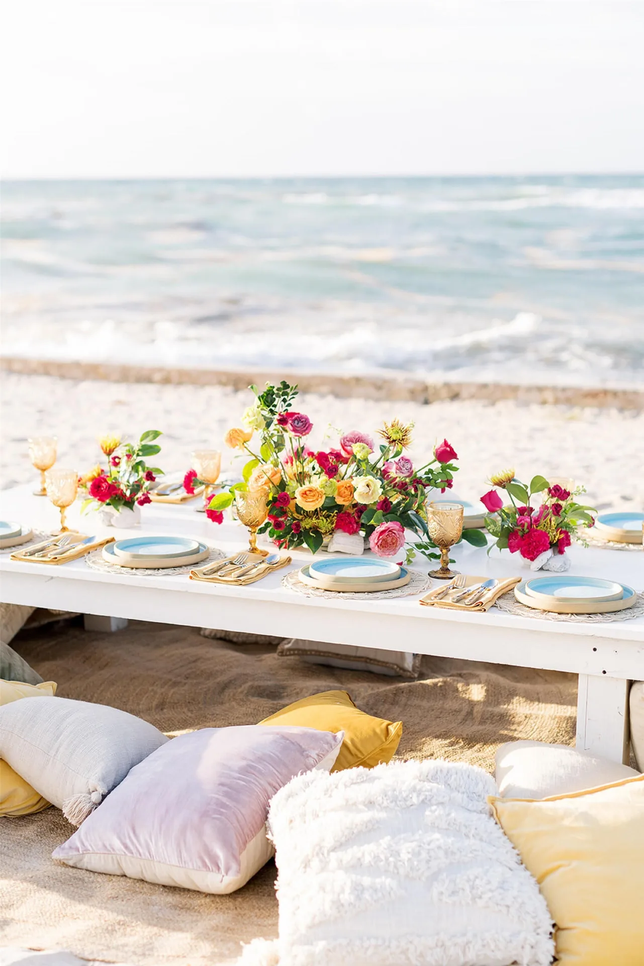 Beach table set with flowers at Conrad Tulum Riviera Maya.