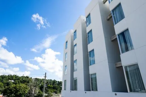 Royal Delonix Hotel highly rated hotel with modern exterior and pool area in Peñuelas, Puerto Rico.