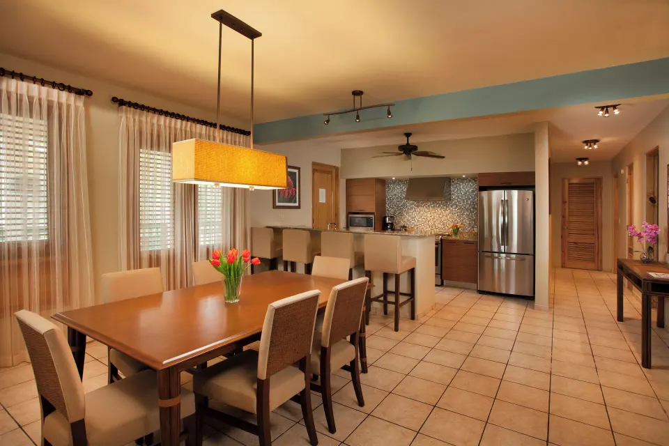 Dining table and kitchen in a resort suite at Copamarina Beach Resort & Spa.