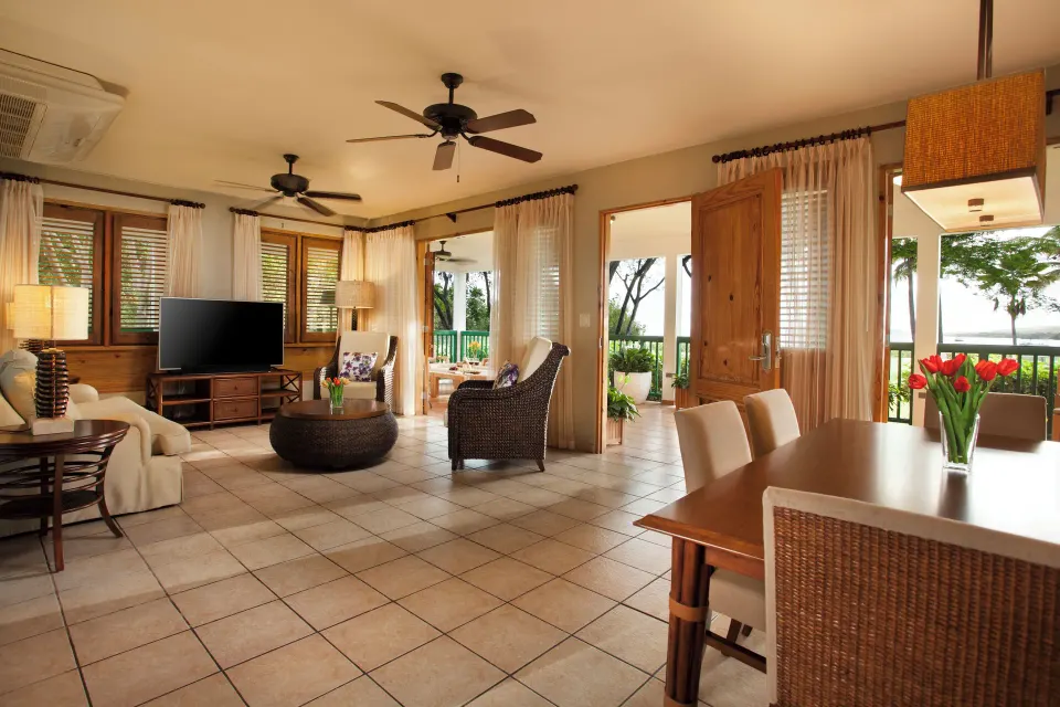 Open suite living and dining area with doors to a patio at Copamarina Beach Resort & Spa.