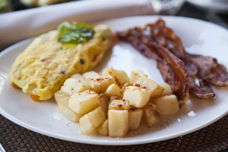 Breakfast plate with omelet, potatoes, and bacon at Copamarina Beach Resort & Spa.
