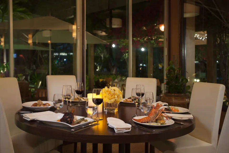 Candlelit dining table with plated meals at Copamarina Beach Resort & Spa.