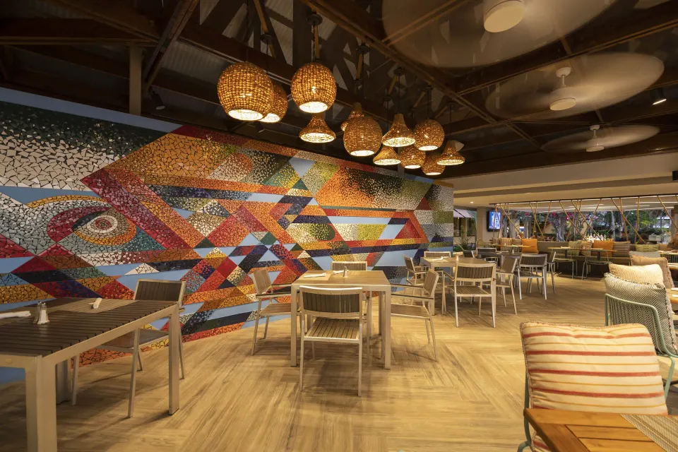 Modern dining area with colorful wall mural at Copamarina Beach Resort & Spa.