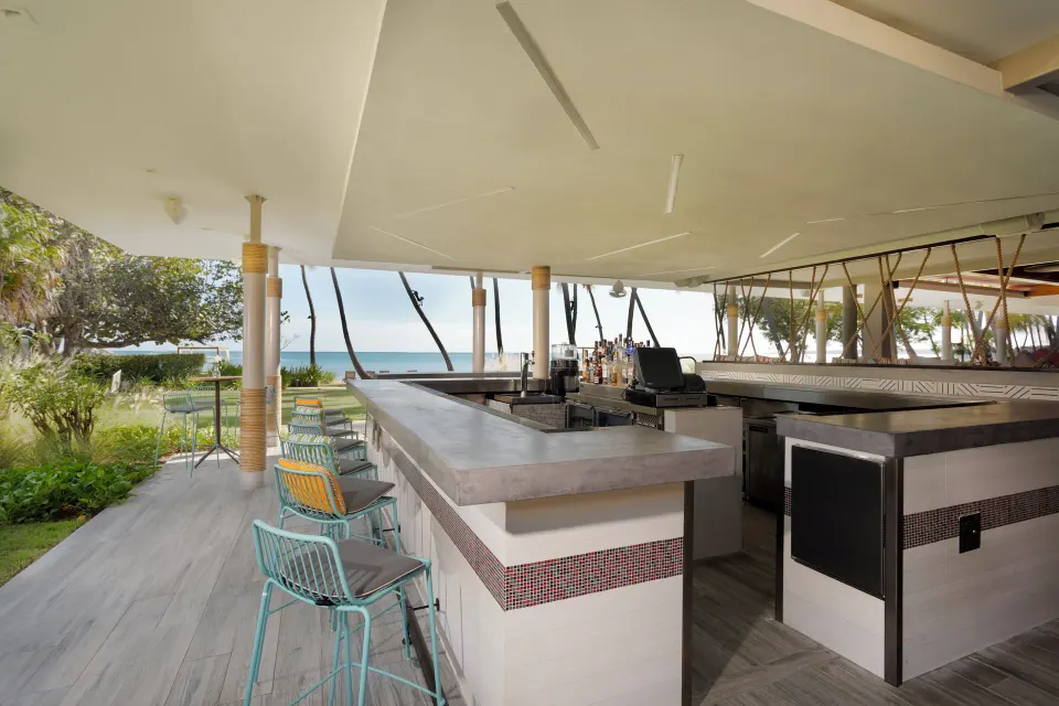 Open-air bar counter with ocean views at Copamarina Beach Resort & Spa.