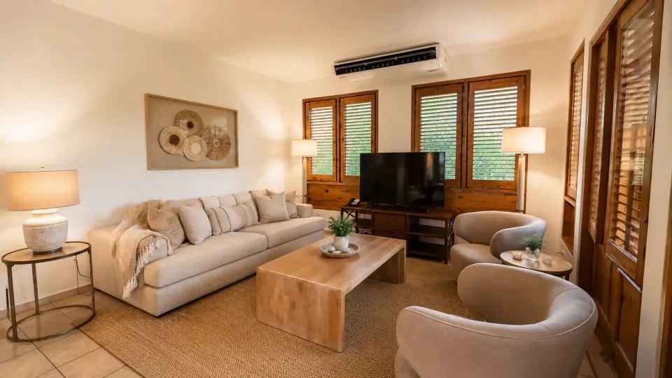 Living room in a Luxury Three-Bedroom Villa at Copamarina Beach Resort & Spa with sofa and TV.