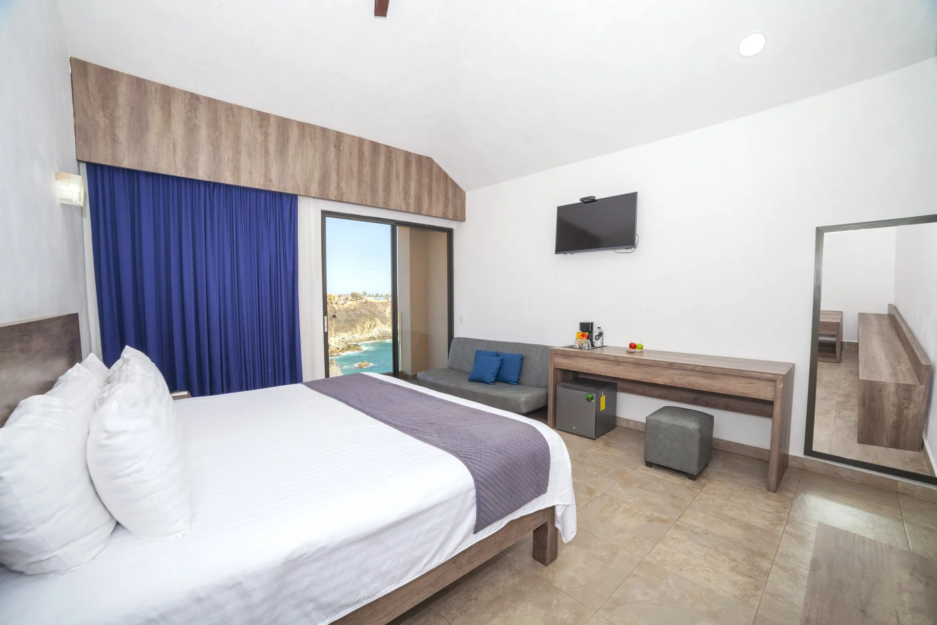 Deluxe Room with king bed and partial ocean view at Coral Blue Huatulco.