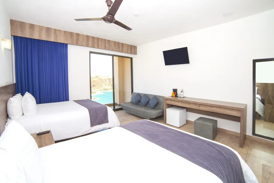 Deluxe Room with two beds and partial ocean view at Coral Blue Huatulco.