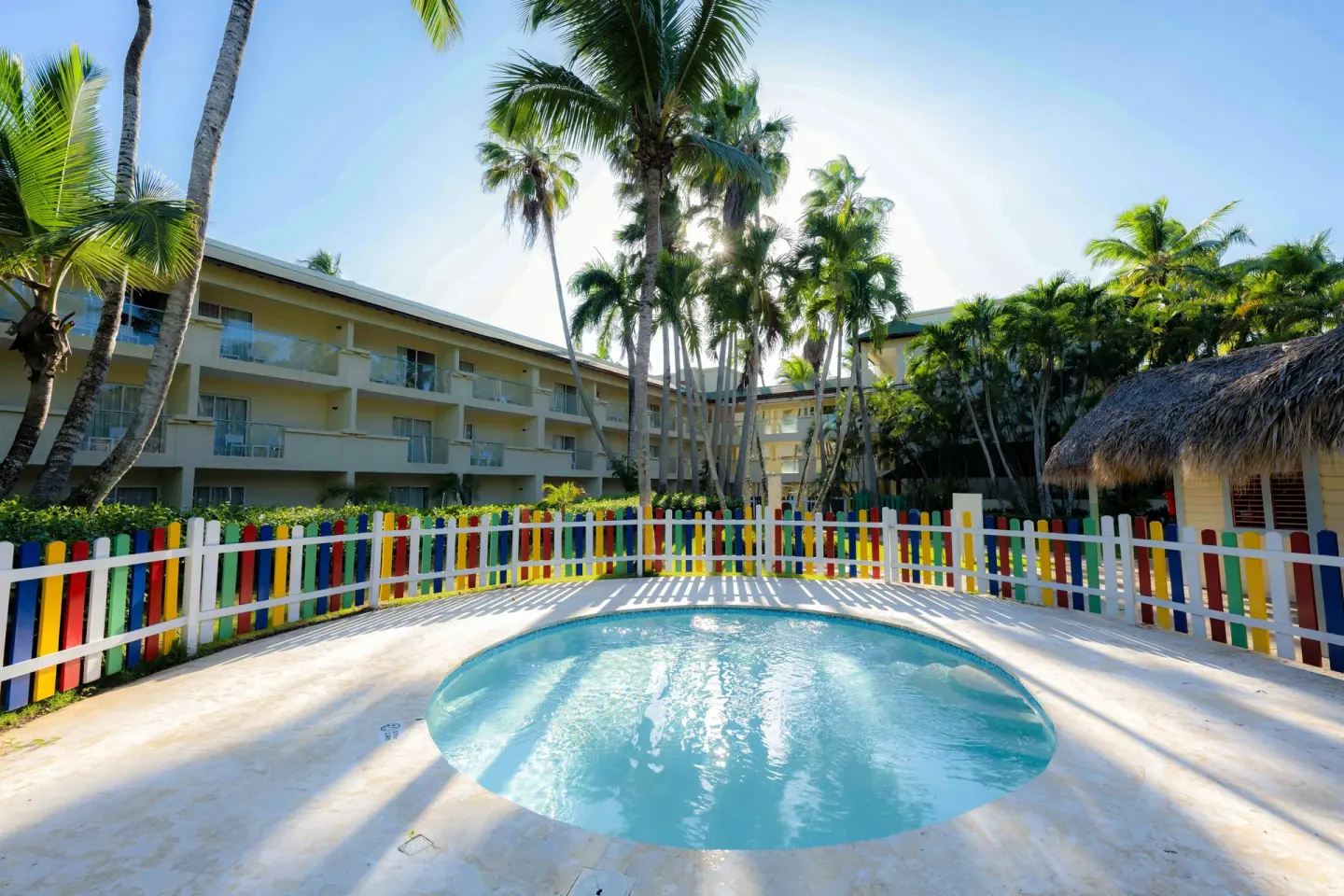 A small fenced children's pool sits beside palms at Coral Costa Caribe Beach Resort.