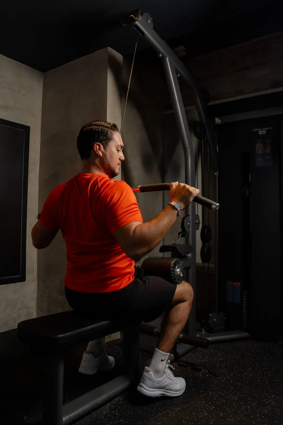 Guest using a cable weight machine in the gym at Coral Costa Caribe Beach Resort.