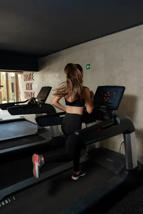 Guest running on a treadmill in the gym at Coral Costa Caribe Beach Resort.