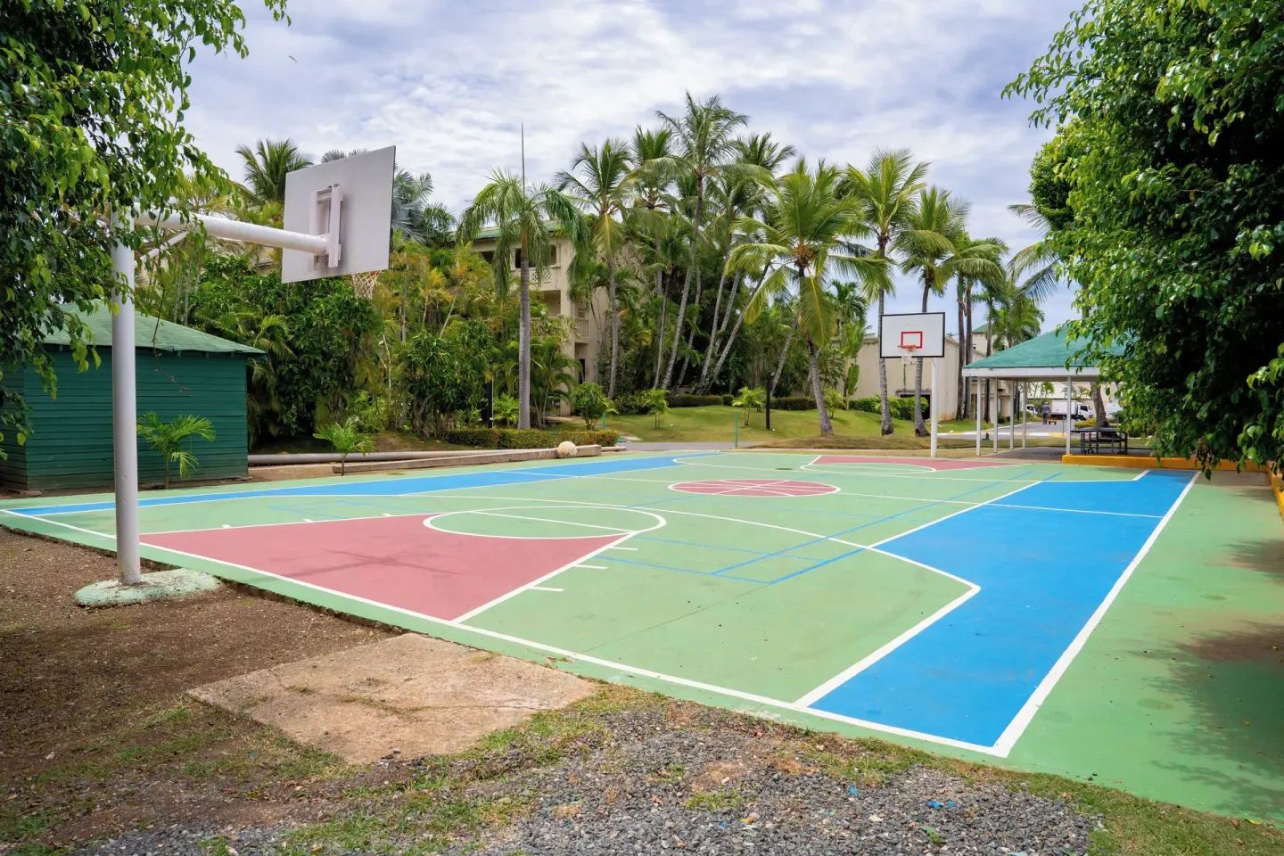 Outdoor basketball court amid palms at Coral Costa Caribe Beach Resort.