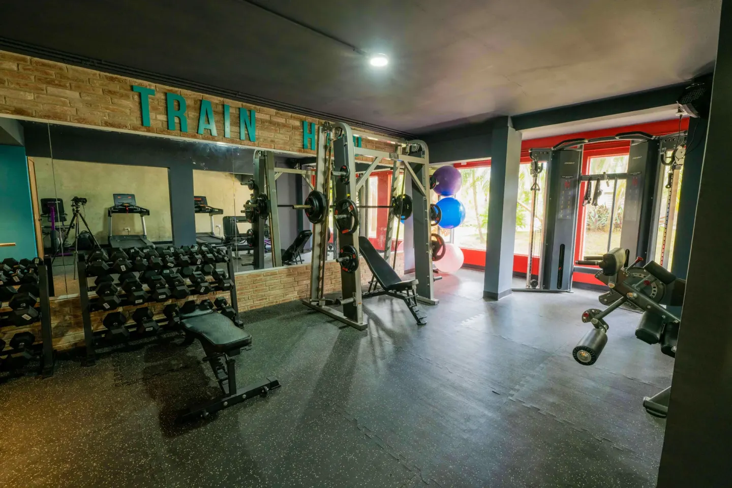 Gym with dumbbells, benches, and cable machines at Coral Costa Caribe Beach Resort.