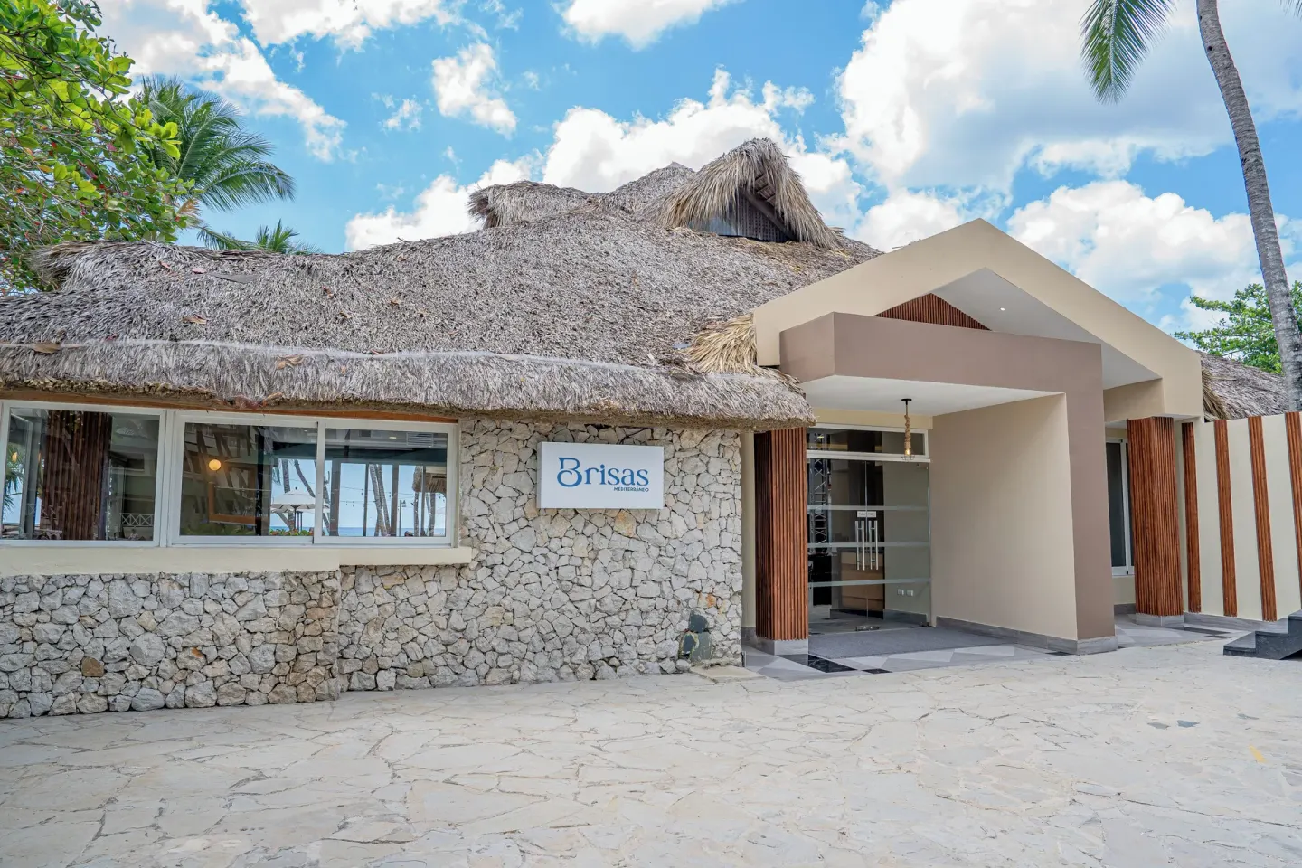 Brisas restaurant entrance with thatched roof at Coral Costa Caribe Beach Resort.
