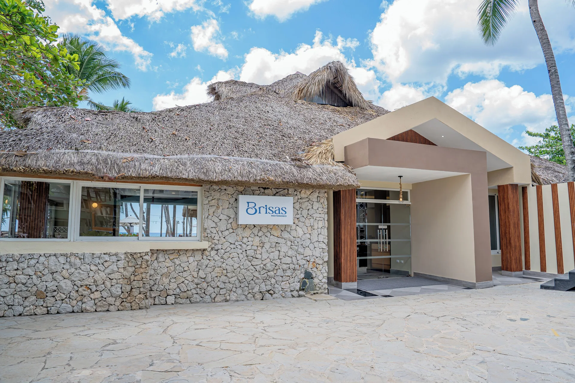 Brisas restaurant entrance with thatched roof at Coral Costa Caribe Beach Resort.
