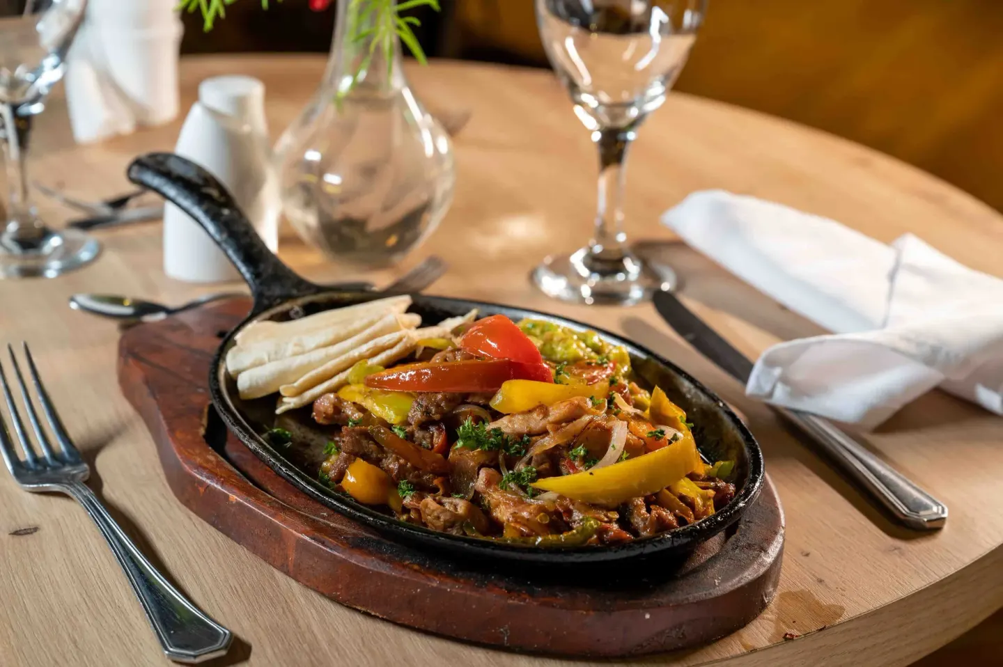 Sizzling skillet of peppers, meat, and tortillas at Coral Costa Caribe Beach Resort.