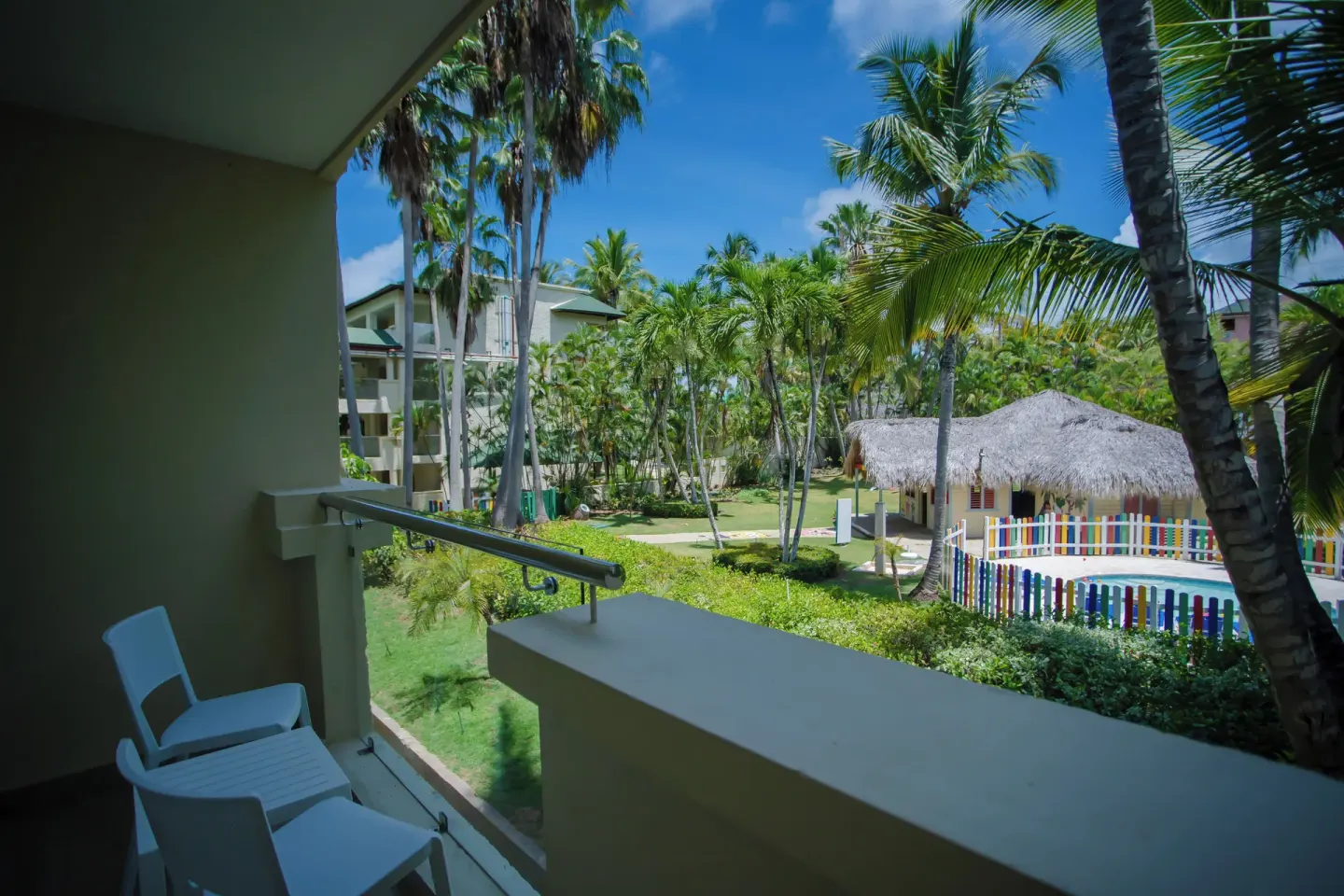 Deluxe Room balcony with garden view at Coral Costa Caribe Beach Resort.