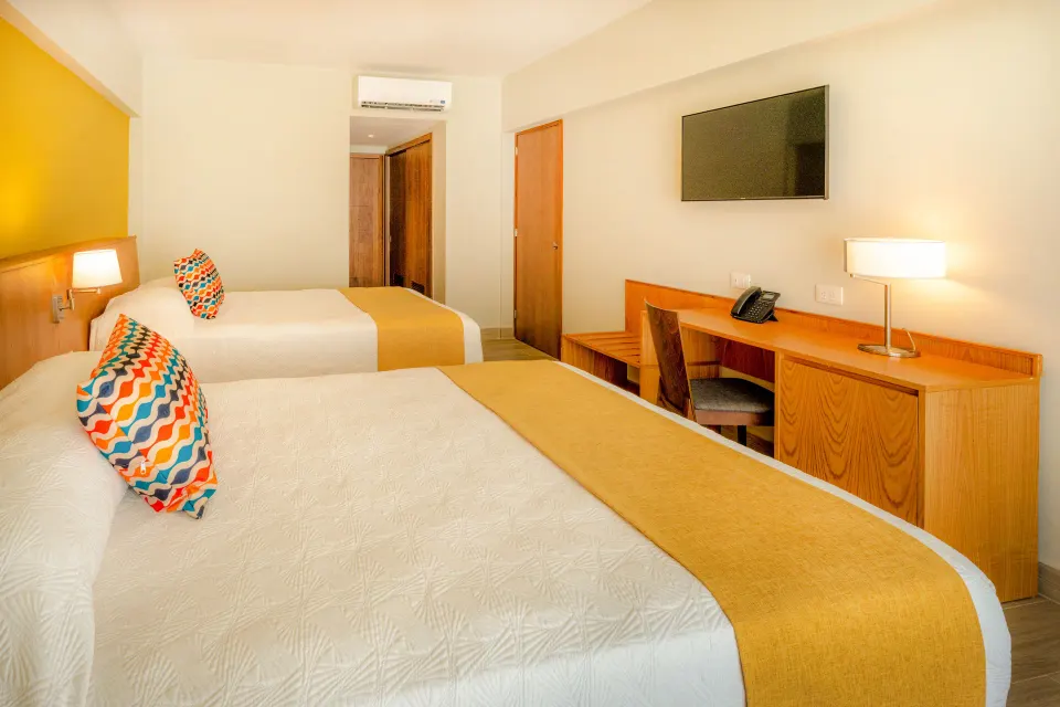 Standard Room Garden View with two beds and desk at Coral Costa Caribe Beach Resort.