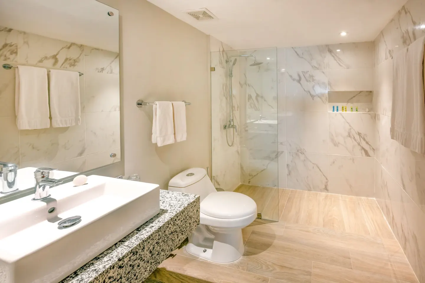 Superior Room bathroom with glass shower at Coral Costa Caribe Beach Resort.