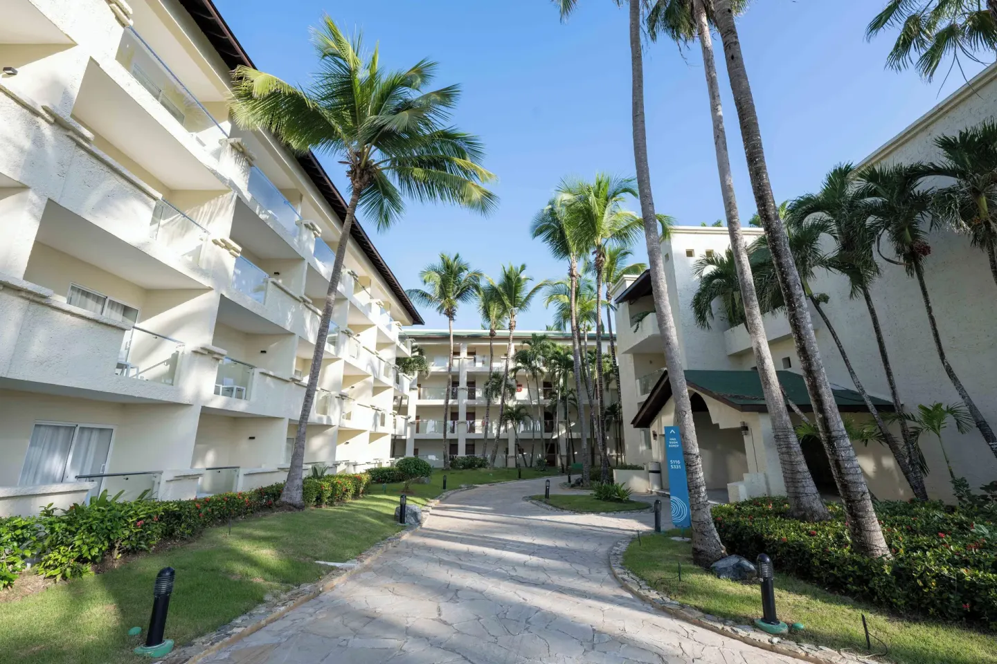 Garden walkway and room balconies at Coral Costa Caribe Beach Resort.