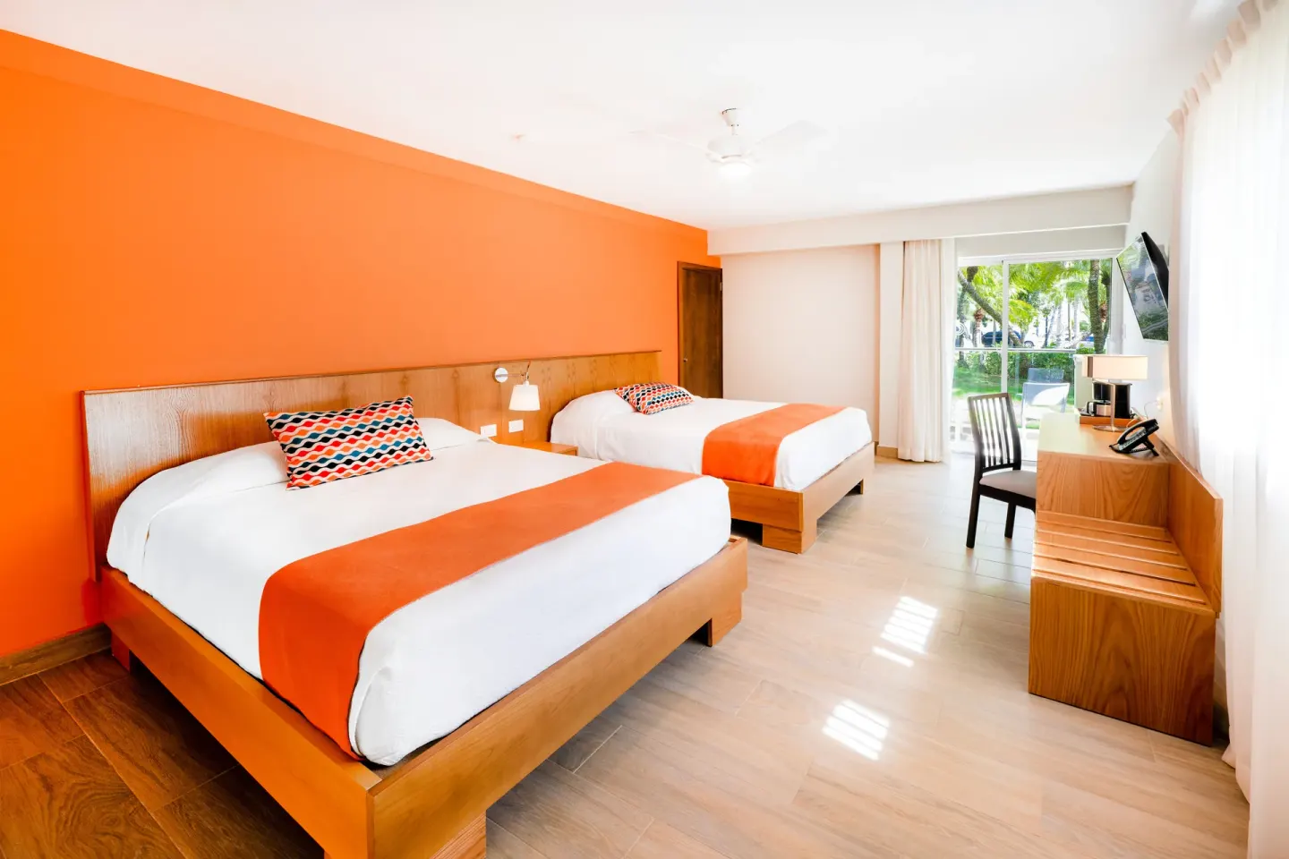 Superior Room with two beds and garden-facing balcony at Coral Costa Caribe Beach Resort.