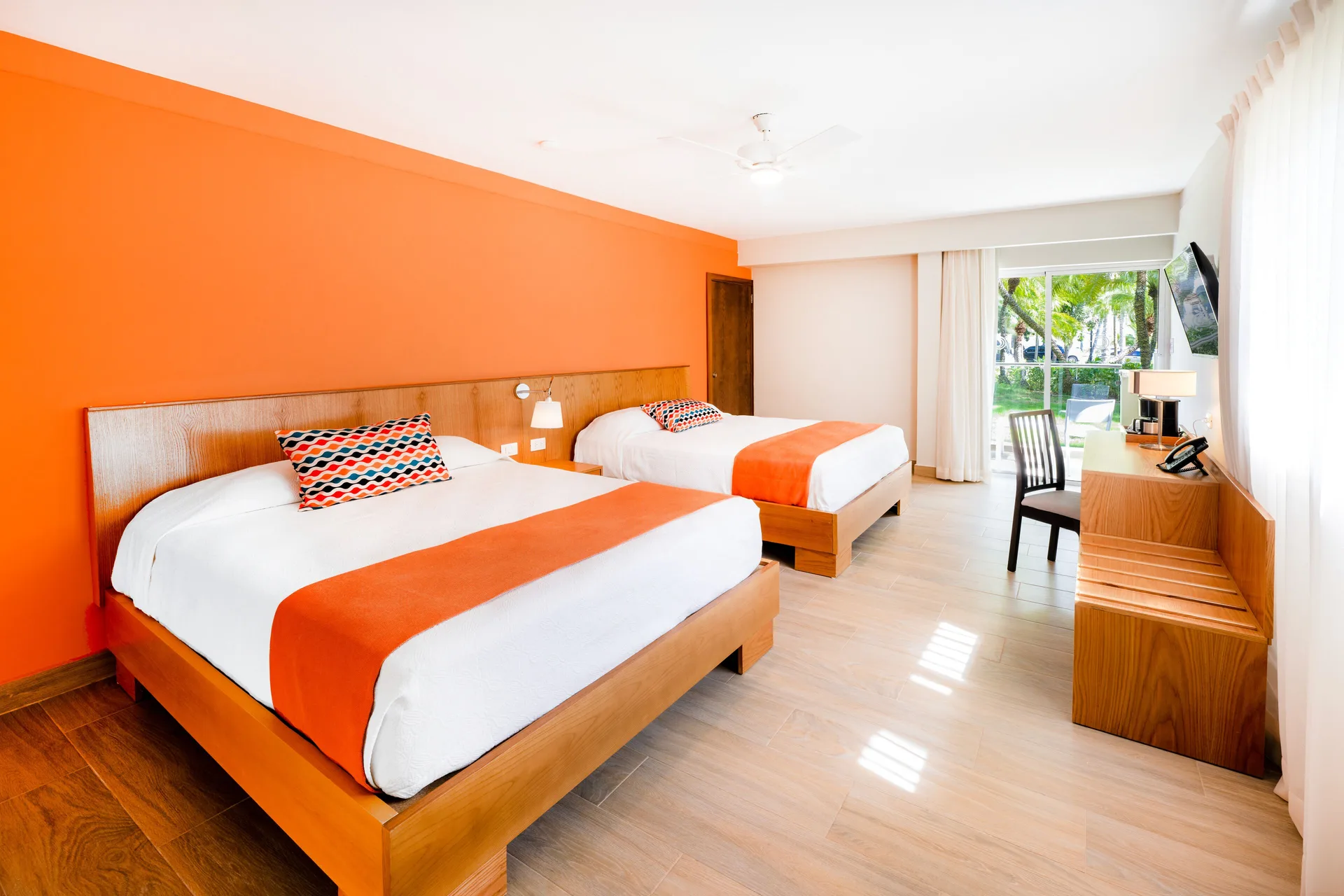 Superior Room Garden View at Coral Costa Caribe Beach Resort with two beds, balcony, and tropical garden views in Juan Dolio.