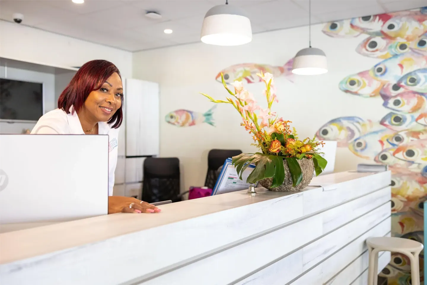Reception desk with fish mural at Coral Estate Luxury Resort.