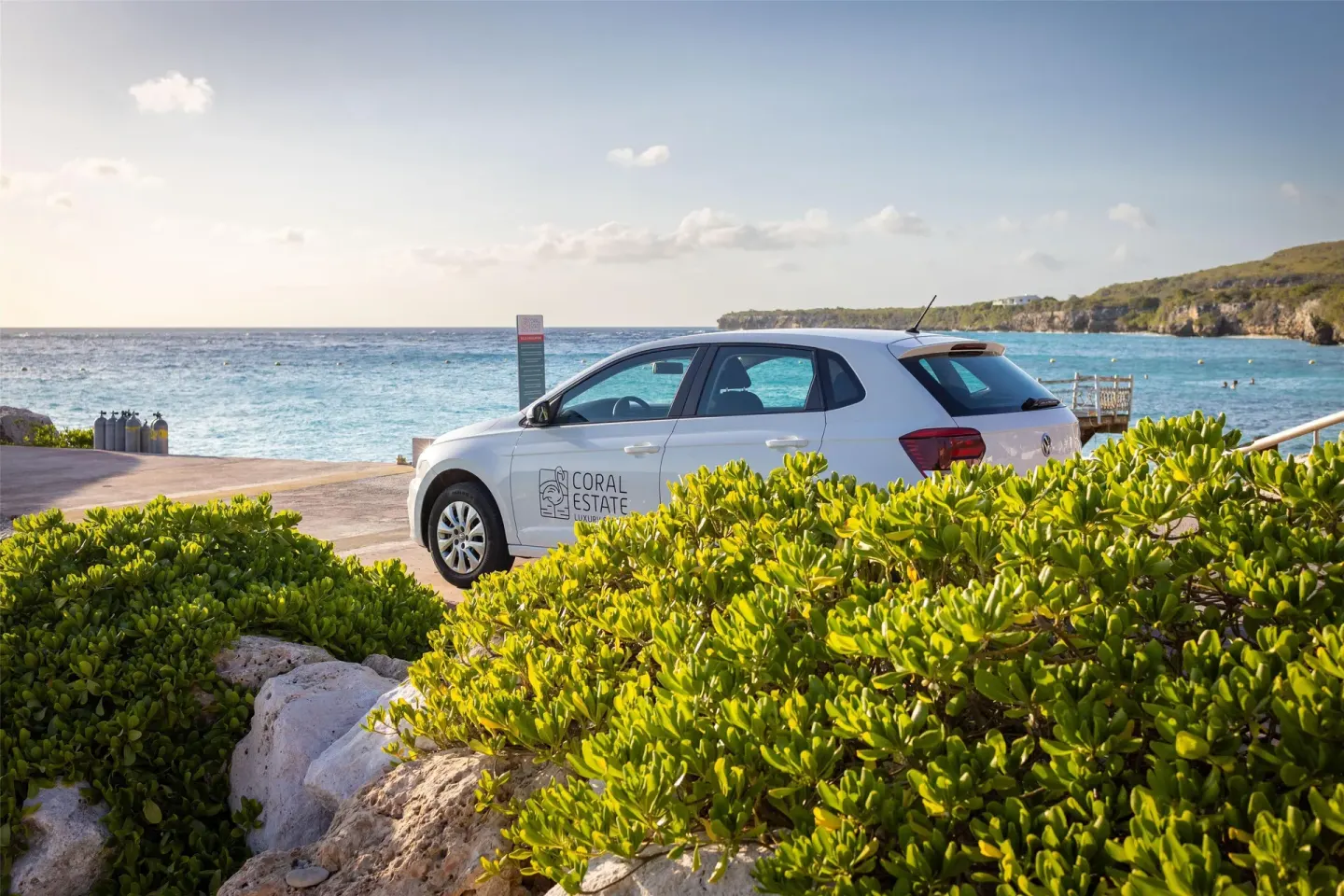 Coral Estate Luxury Resort branded car parked by the sea at Coral Estate Luxury Resort.