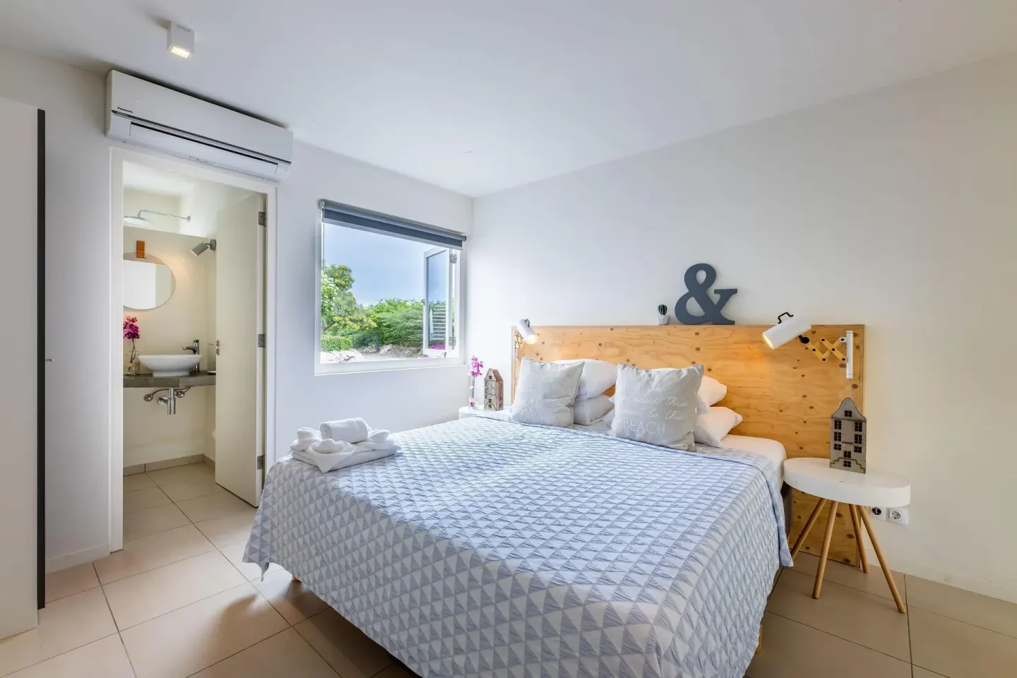 Deluxe apartment bedroom with ensuite bathroom at Coral Estate Luxury Resort.