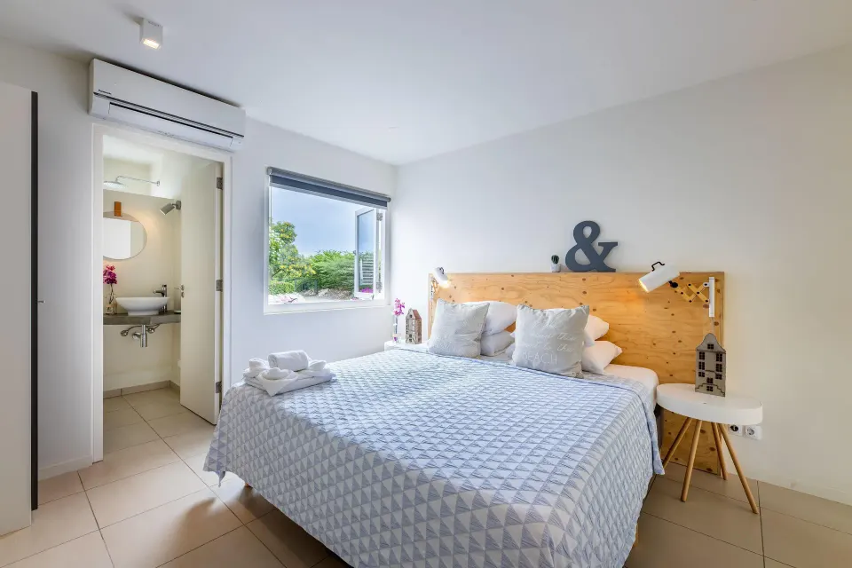 Deluxe apartment bedroom with ensuite bathroom at Coral Estate Luxury Resort.