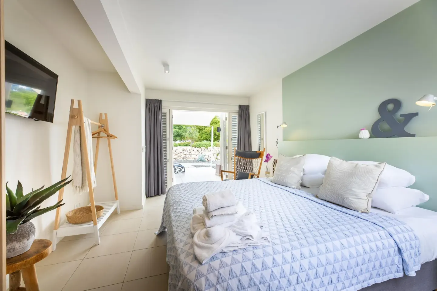 Deluxe apartment bedroom with terrace doors and garden view at Coral Estate Luxury Resort.