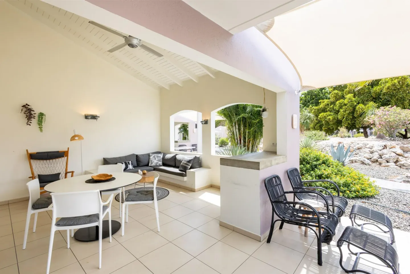 Covered garden-view terrace seating at Coral Estate Luxury Resort.