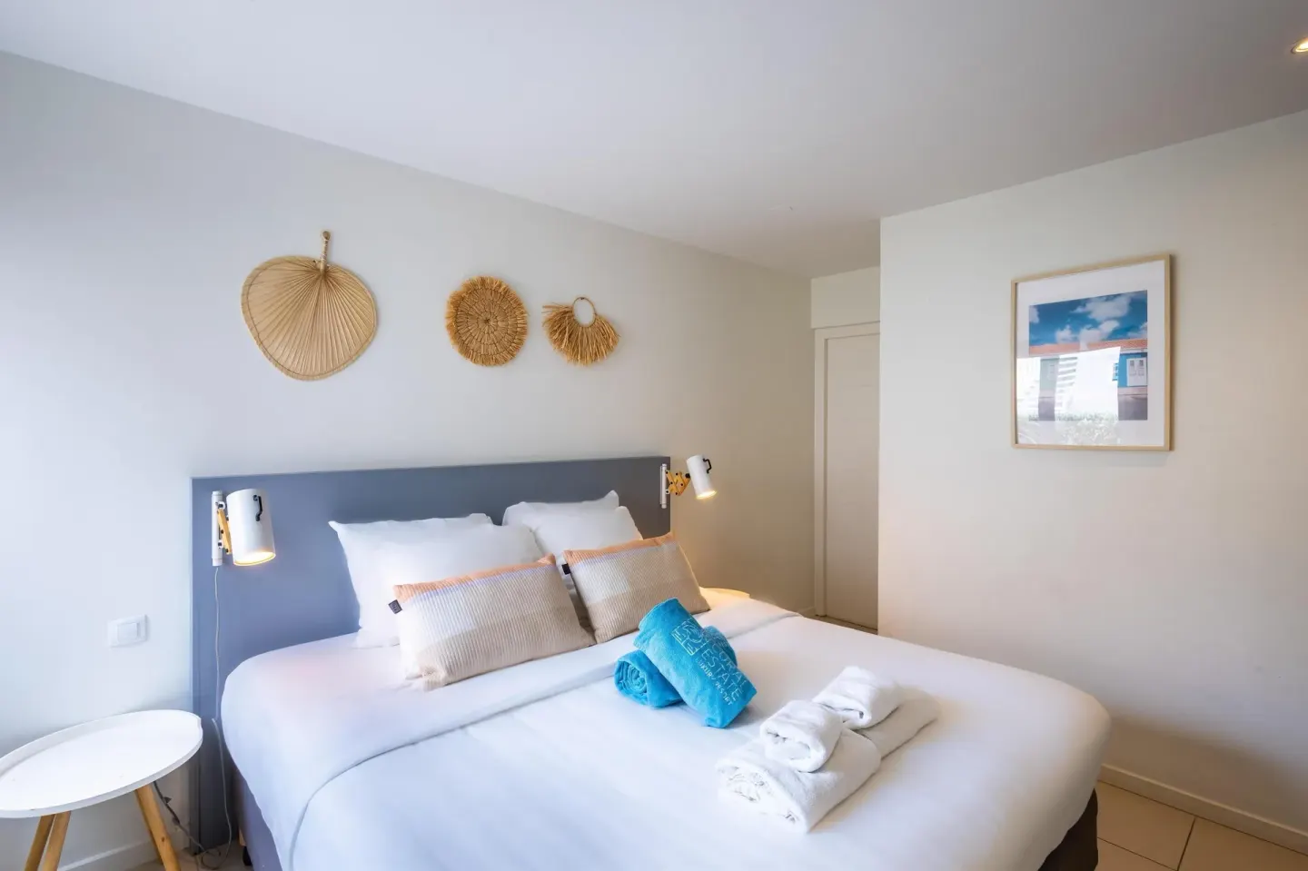 Bedroom with a double bed and woven wall decor at Coral Estate Luxury Resort.