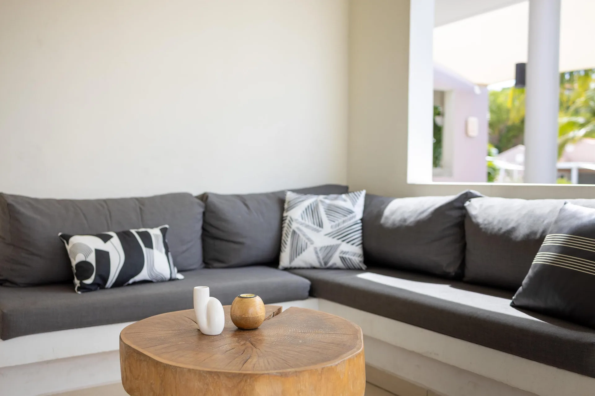 Close-up of the gray sofa lounge in a garden-view apartment at Coral Estate Luxury Resort.