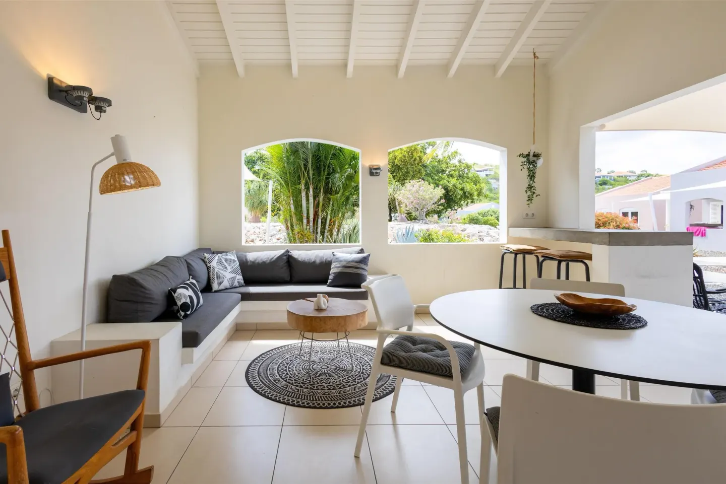 Apartment living and dining area with arched garden openings at Coral Estate Luxury Resort.