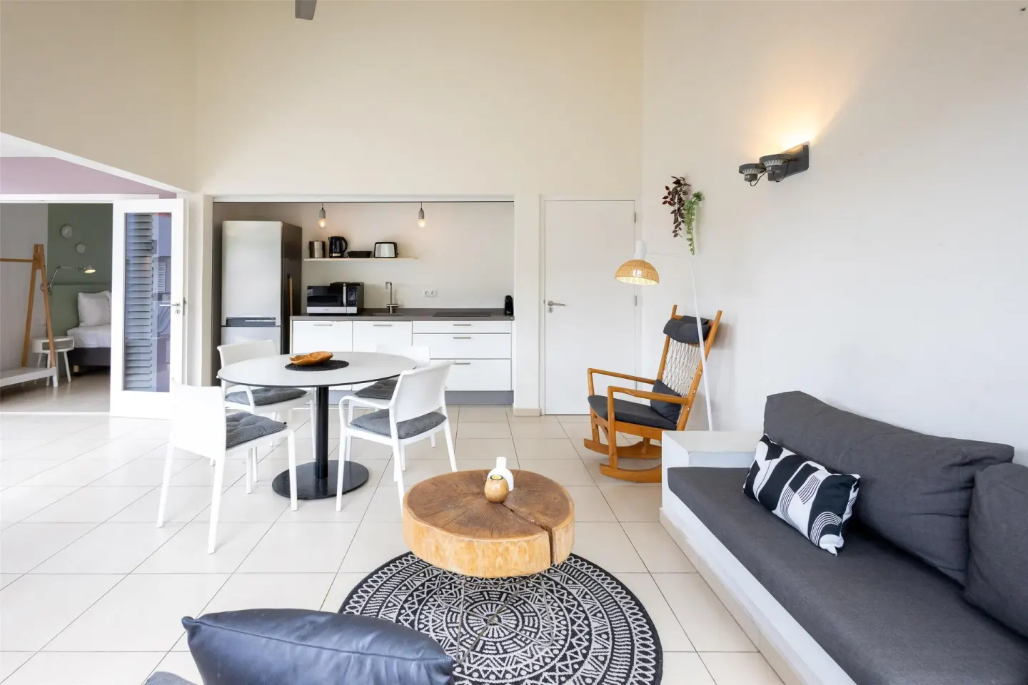 Open apartment living area with kitchenette at Coral Estate Luxury Resort.
