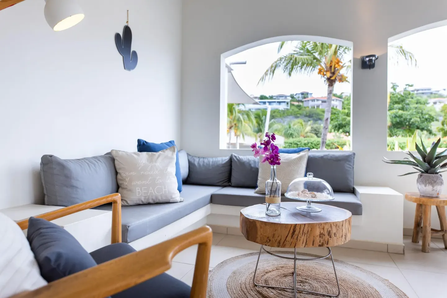 Garden-view apartment lounge with gray sofas at Coral Estate Luxury Resort.