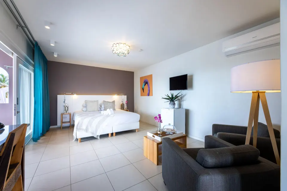 Deluxe Room Garden View king bed and seating area at Coral Estate Luxury Resort.