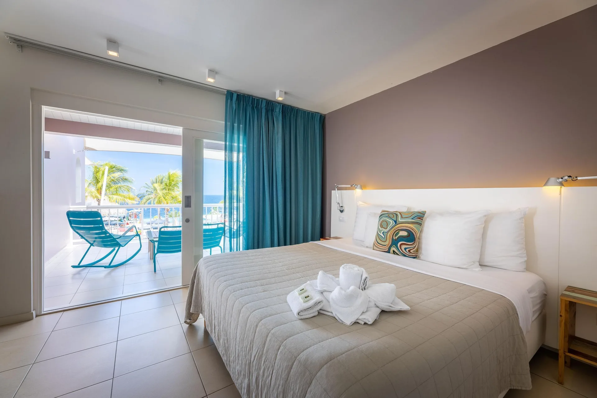 Ocean Pool View Deluxe Suite at Coral Estate Luxury Resort with king bed, pool access, and partial ocean view in Curaçao.
