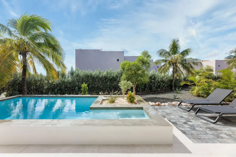 Premium Villa private pool with loungers and palms at Coral Estate Luxury Resort.