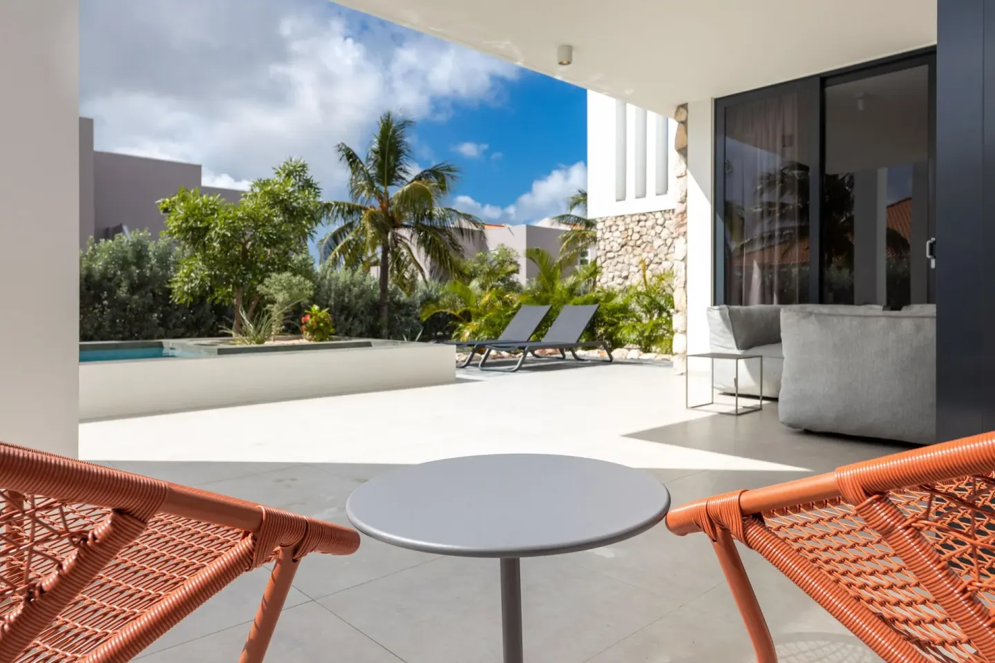 Premium Villa patio chairs facing the pool at Coral Estate Luxury Resort.